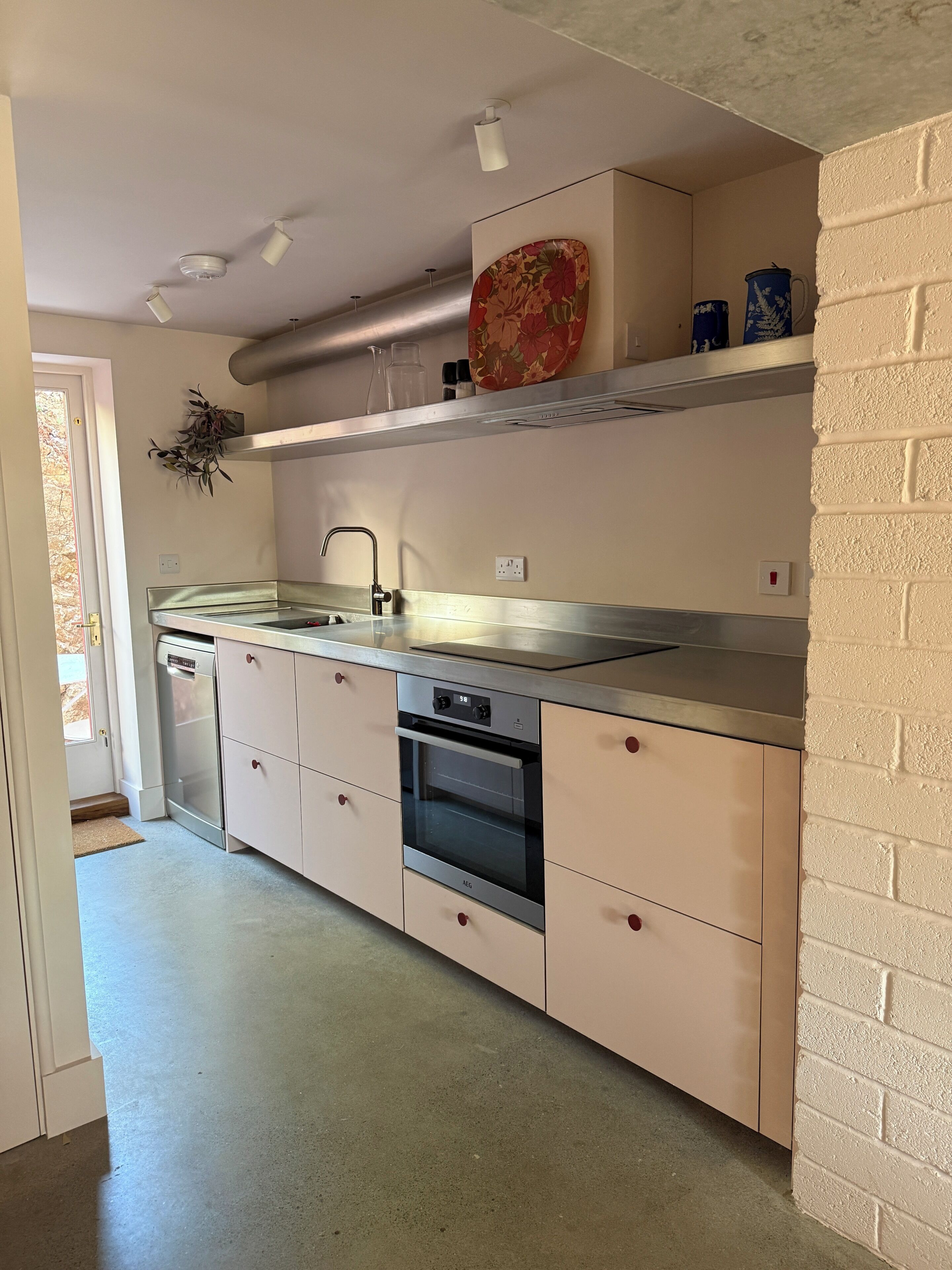 A kitchen with a stainless steel sink, a dishwasher, and a built-in oven.