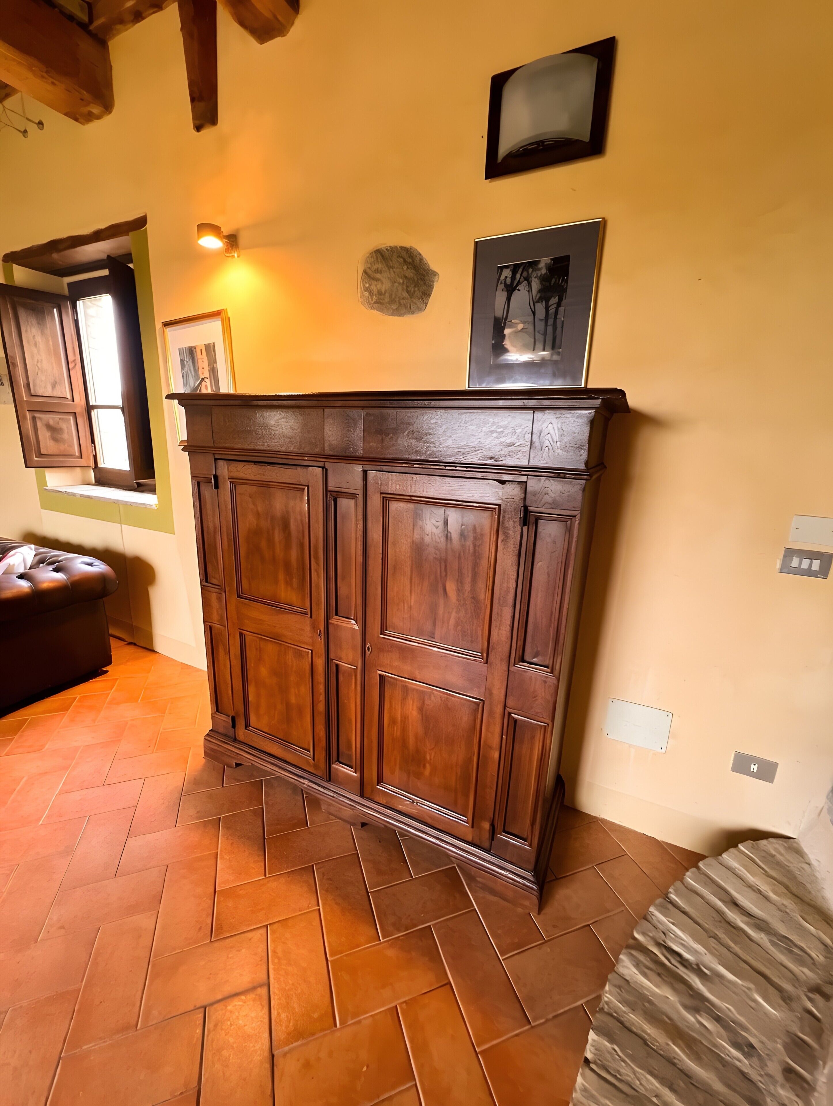 A wooden cabinet with a herringbone floor pattern.