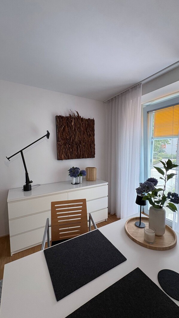 A modern room with a desk, chair, and a decorative wall piece.