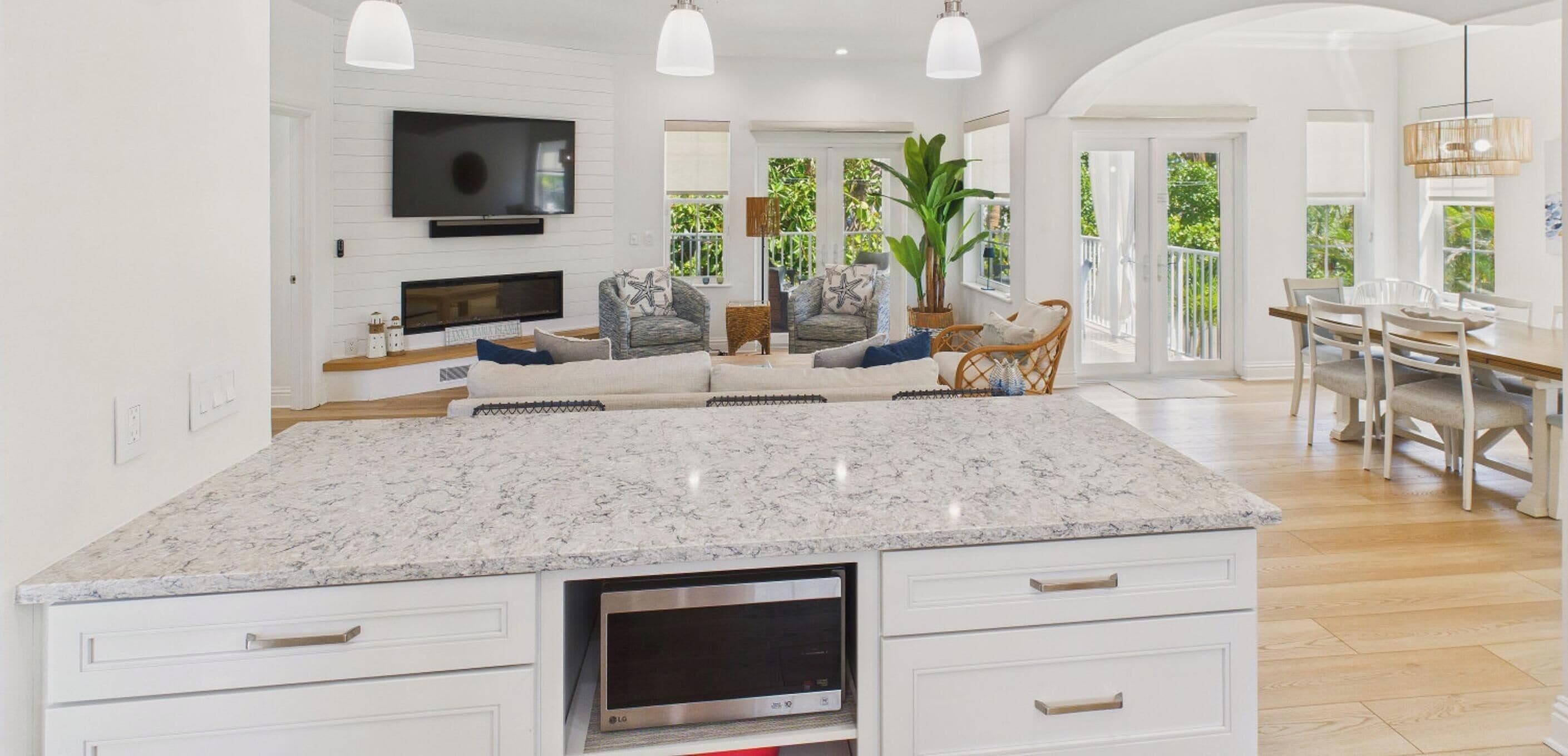 A spacious kitchen with a large island, built-in appliances, and a dining area with natural light.