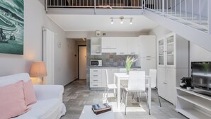 A modern apartment with a living room, dining area, kitchenette, and a balcony. - Loft Lingotto by Wonderful Italy (Turin)