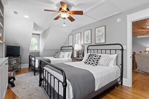 A bedroom with two beds, a ceiling fan, and artwork on the walls. - McLemore Resort - 68 Founder Path - Walking distance to Range and Clubhouse (Rising Fawn)