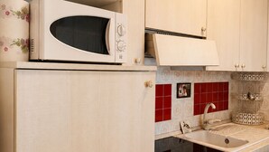 A kitchen with a microwave, a sink, and a dishwasher.