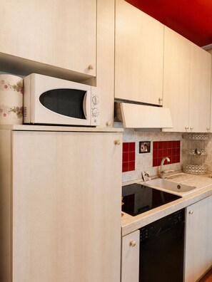 A kitchen with a microwave, a sink, and a dishwasher.