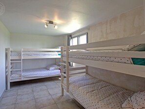 A bunk bed room with a window, a ceiling light, and a tiled floor. - Renovated house, private pool - 18 guests (Sail-les-Bains)