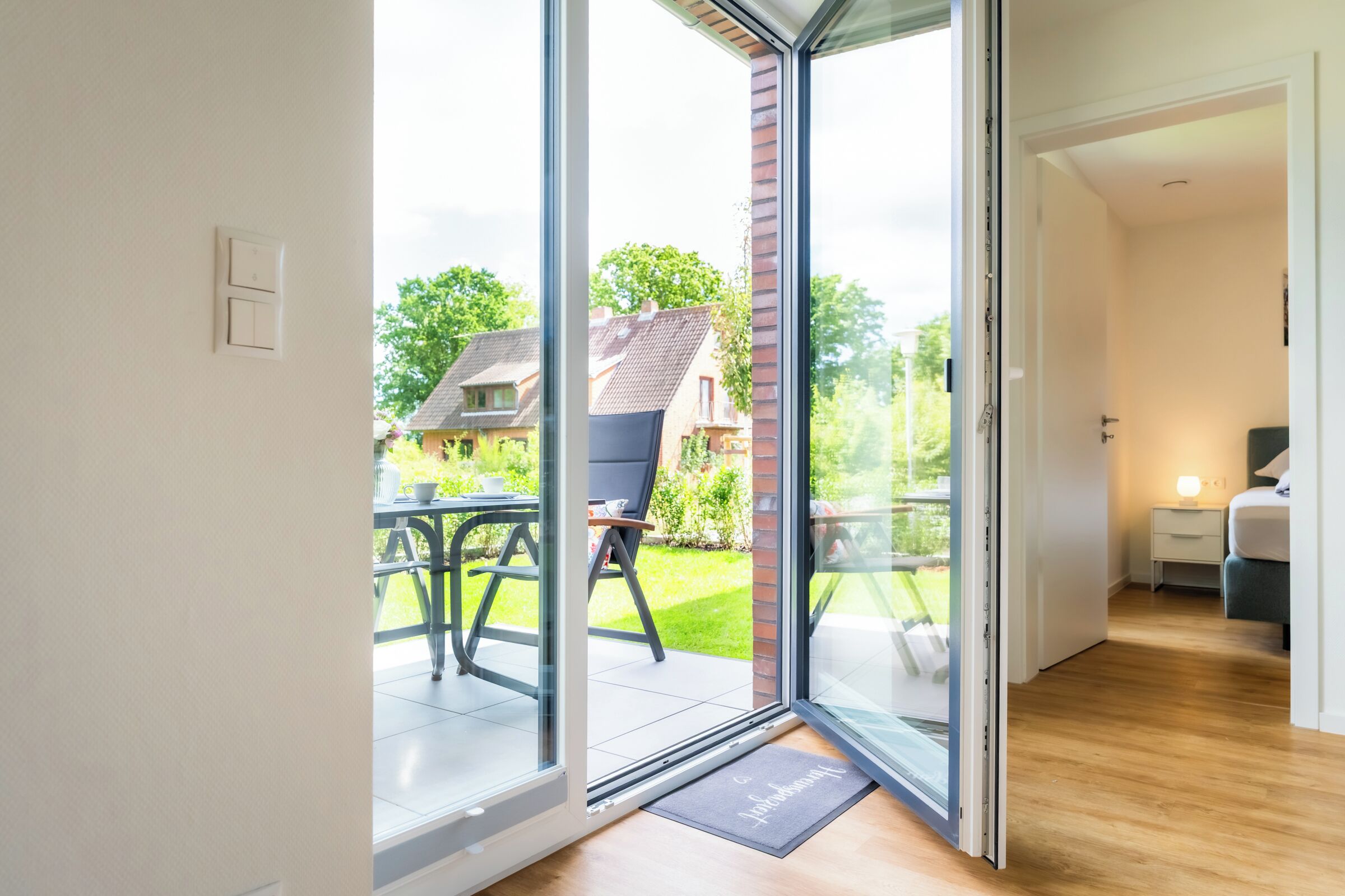 A modern interior with a sliding glass door leading to a patio area.
