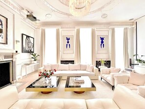 A spacious living room with a fireplace, two sofas, and a coffee table.