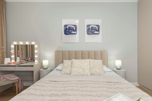 A bedroom with a bed, a vanity with lights, two framed artworks, and a nightstand with a lamp. - Comfortable Apartment with a Garden | Parking (Gdańsk)