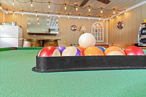 A pool table with a black felt surface and a set of colorful balls. - 2-Acre Retreat Near Ocean City + Game Room (Berlin)