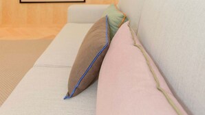 A modern living room with a sofa, pillows, and a framed artwork on the wall. - Allegro Boutique Apartment 1D by Liiiving (Porto)