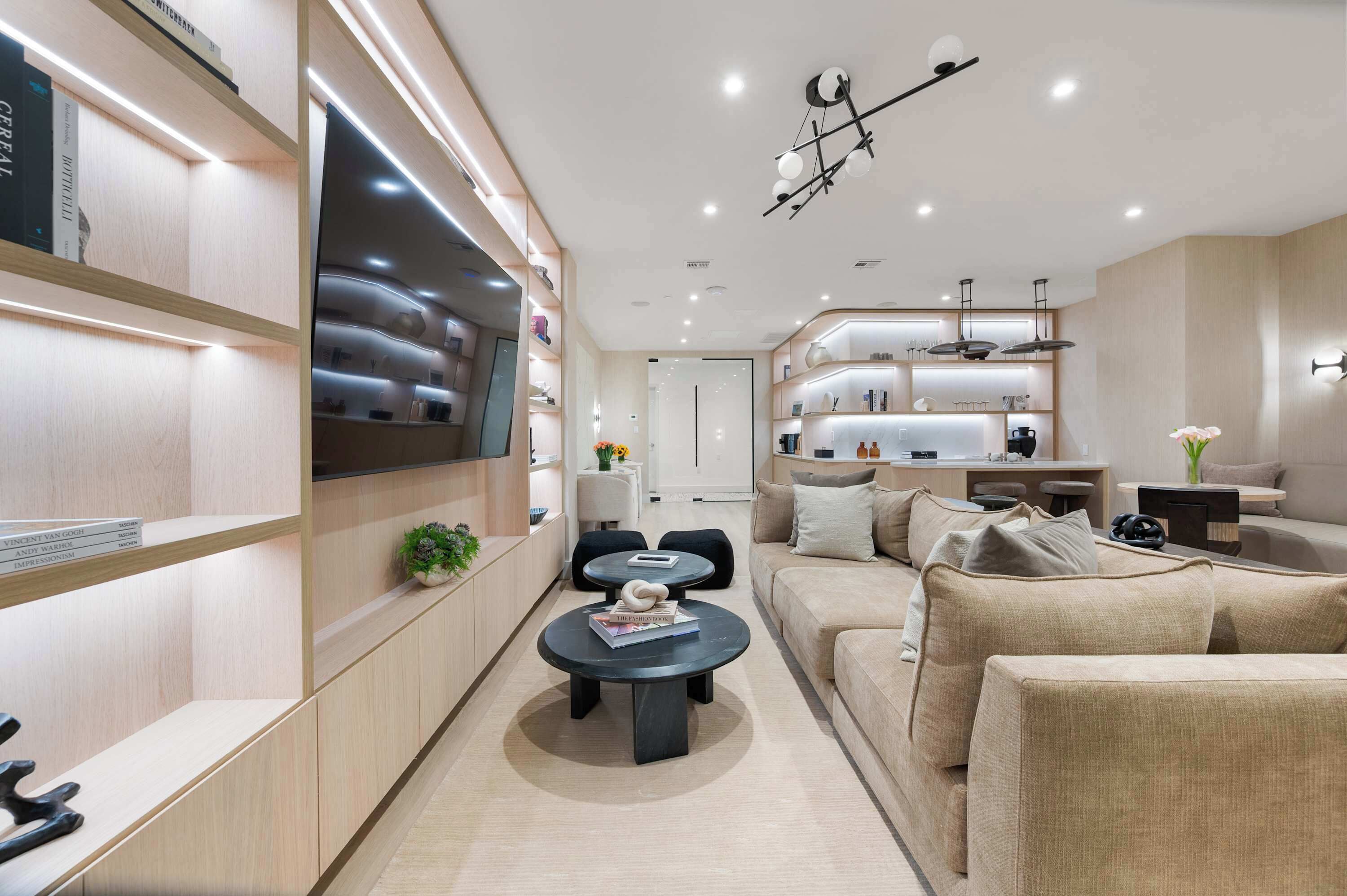 A modern living room with a sofa, coffee table, and shelves.