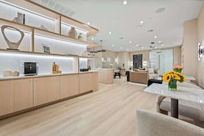 A modern kitchen with built-in appliances, a dining area with a marble table, and a living room with a sofa and coffee table. - 17john: Luxury 3 Bed W/D in Unit + GYM + Lounge (New York)