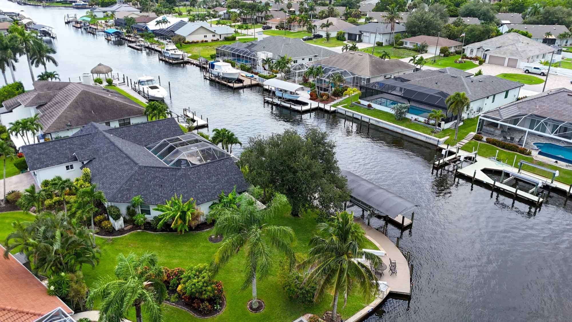 A residential area with houses, a marina, and a swimming pool.