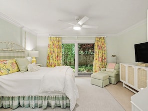 A bedroom with a bed, a television, a desk, and a window with curtains. - Beautiful Breakers East Condo with Lake Michigan Views (Harbor Springs)