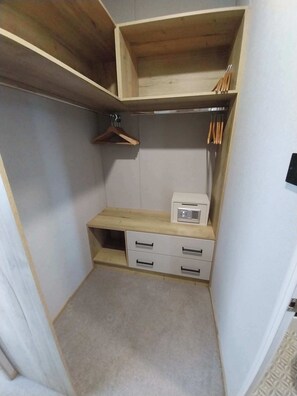 A small, enclosed closet with wooden shelves, a hanging rack, and a radio. - Kielder - Spacious 3 Bed, Luxury Lodge, Haven, Seton Sands (Port Seton)