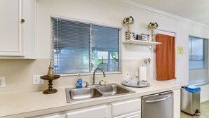 A kitchen with a double sink, a dish rack, a vase, and a bottle of Dawn dish soap. - 2-unit Combo 10 Mi to Vintage Park & Airport! (Houston)