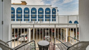 A building with blue arched windows and a white facade. - Unwind Poolside, Walk to Shore! Orange Beach Condo (Orange Beach)