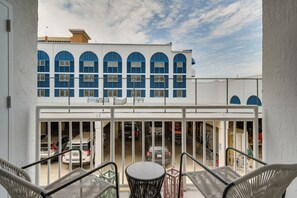 A building with blue arched windows and a white facade. - Unwind Poolside, Walk to Shore! Orange Beach Condo (Orange Beach)