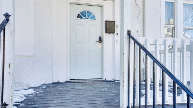A white door with a window, a mailbox, and a metal gate. - Spacious Newark Duplex w/ 2 Levels & 2 Kitchens! (Newark)