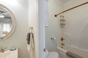 Un baño con inodoro, bidé, toallero, espejo y zona de ducha.