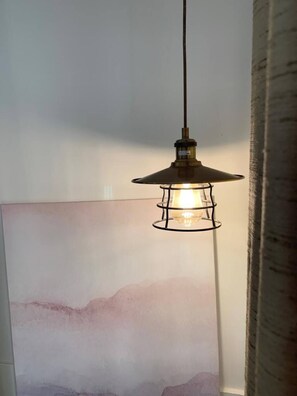 A pendant light fixture with a metal frame and a conical shade, hanging from a ceiling. - Ground-floor maisonette just steps from the seafront (Tas-Sliema)