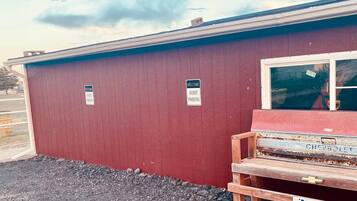 A red building with a sign indicating guest parking.