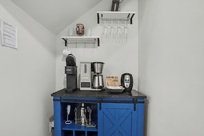 A kitchenette with a coffee maker, toaster, and a coffee pot. - New on Program! The Townes at Barefoot #5202! Your Favorite Place to Golf! (North Myrtle Beach)
