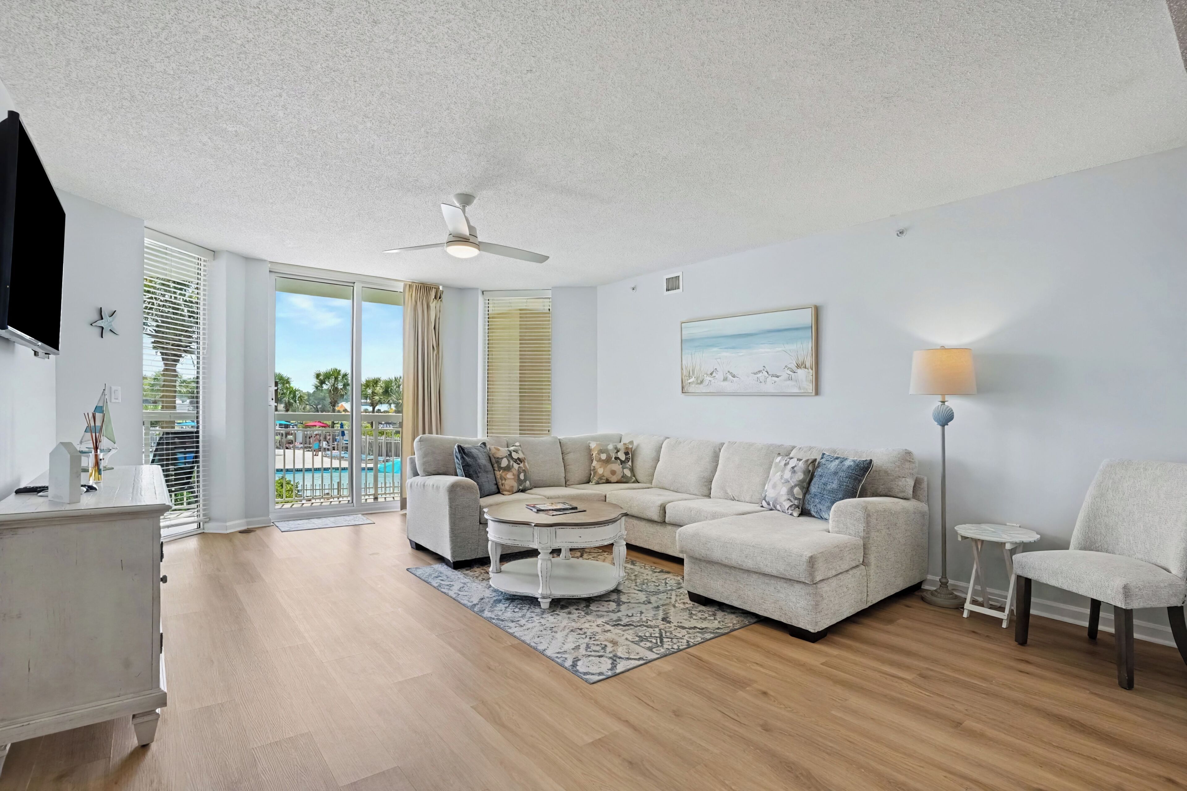 A modern living room with a sectional sofa, a coffee table, and a floor lamp.