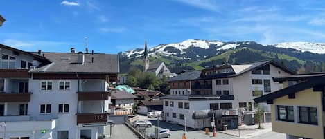 A mountain town with a church, hotel, and residential buildings.