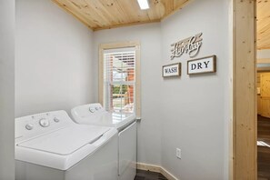 A laundry room with a washing machine, a dryer, and a window with blinds. There are signs on the wall that read 'Laundry Wash Dry'. - Majestic Valley View 3 Bedroom Cabin (Sevierville)