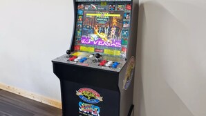 A vintage arcade machine with a screen displaying a fighting game, joystick controls, and a coin slot. - Majestic Valley View 3 Bedroom Cabin (Sevierville)