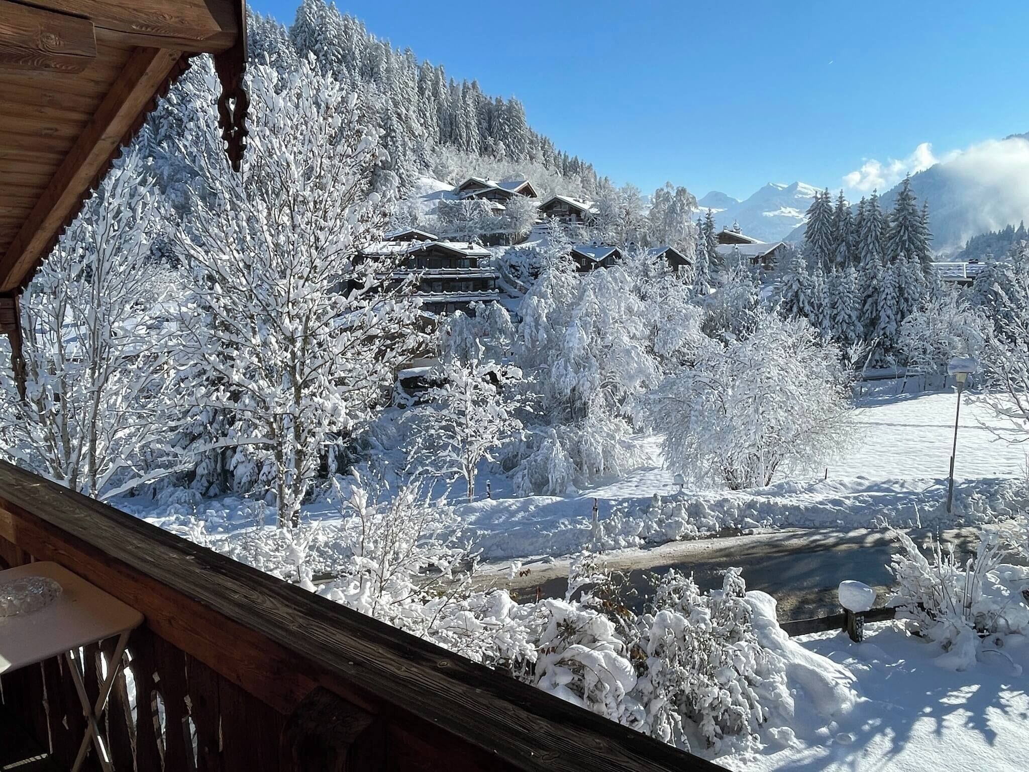 A snowy mountain landscape with wooden cabins and a clear sky.