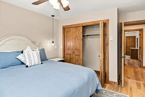 A bedroom with a bed, a wardrobe, a ceiling fan, and a nightstand. - Mountain Retreat, Fireplace & Mountain Views | SF203 (Vail)