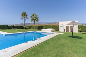 A swimming pool with a clear view of the mountains in the background.