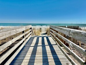 A wooden boardwalk leading to a beach with a clear sky. - Oceanfront 1BR Sleeps 4-6 Myrtle Beach 421 (Myrtle Beach)