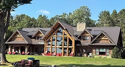 Spacious 5-bedroom lodge on Bone Lake with 2 guest cabins, pickleball and sauna.