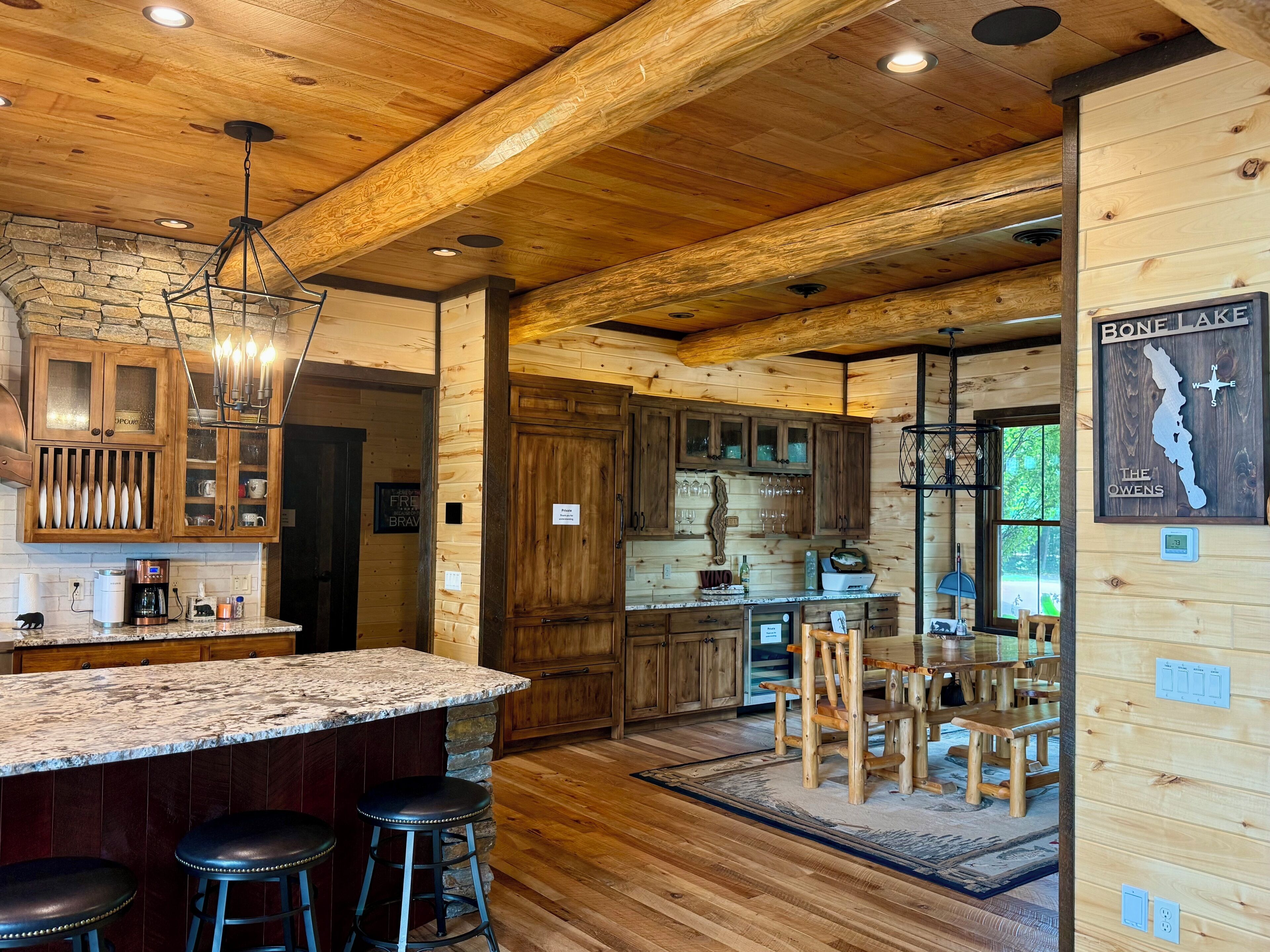 A wooden interior with a kitchen, bar area, and dining space.