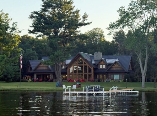 Spacious 5-bedroom lodge on Bone Lake with 2 guest cabins, pickleball and sauna.