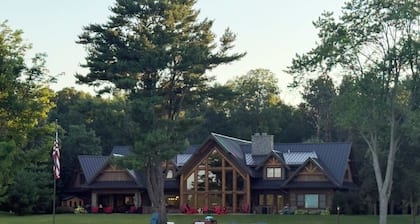 Spacious 5-bedroom lodge on Bone Lake with 2 guest cabins, pickleball and sauna.