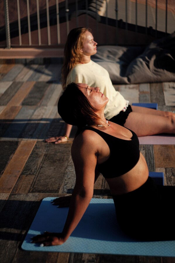 A person performing a yoga pose on a blue mat.