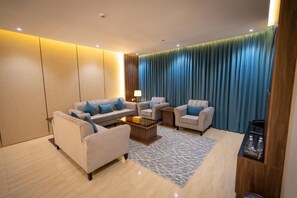 A modern living room with a sofa set, a coffee table, and a side table.