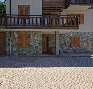 A two-story building with stone walls and wooden shutters on the windows. - House with garden and garage near the slopes (San Pietro)
