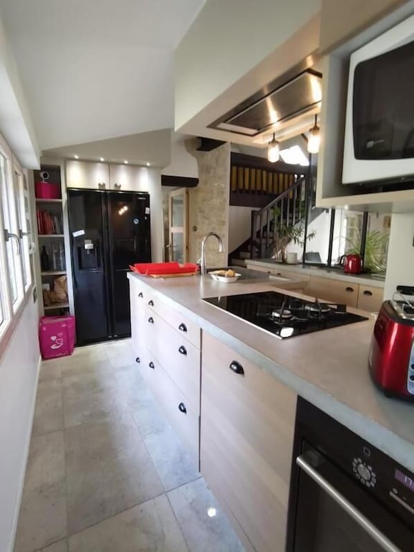 A modern kitchen with a built-in stove, a microwave, and a dishwasher.