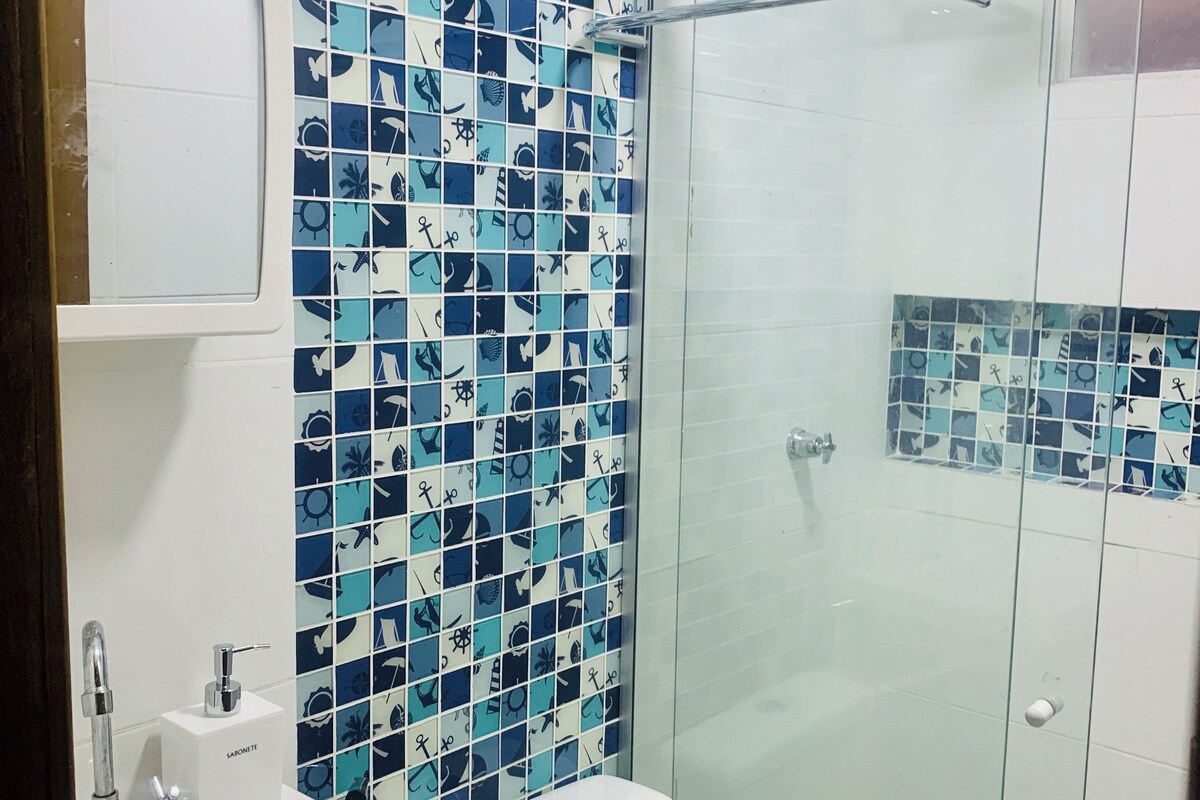 Une salle de bain avec une douche, un lavabo et des toilettes.