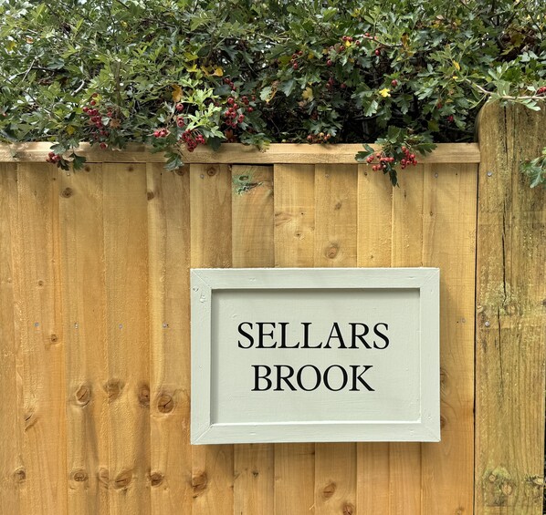 A wooden fence with a sign that reads 'SELLARS BROOK'.
