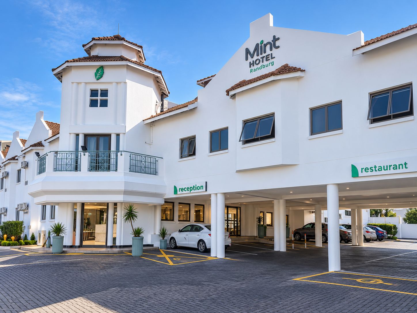 A hotel with a reception area, a restaurant, and a parking lot.