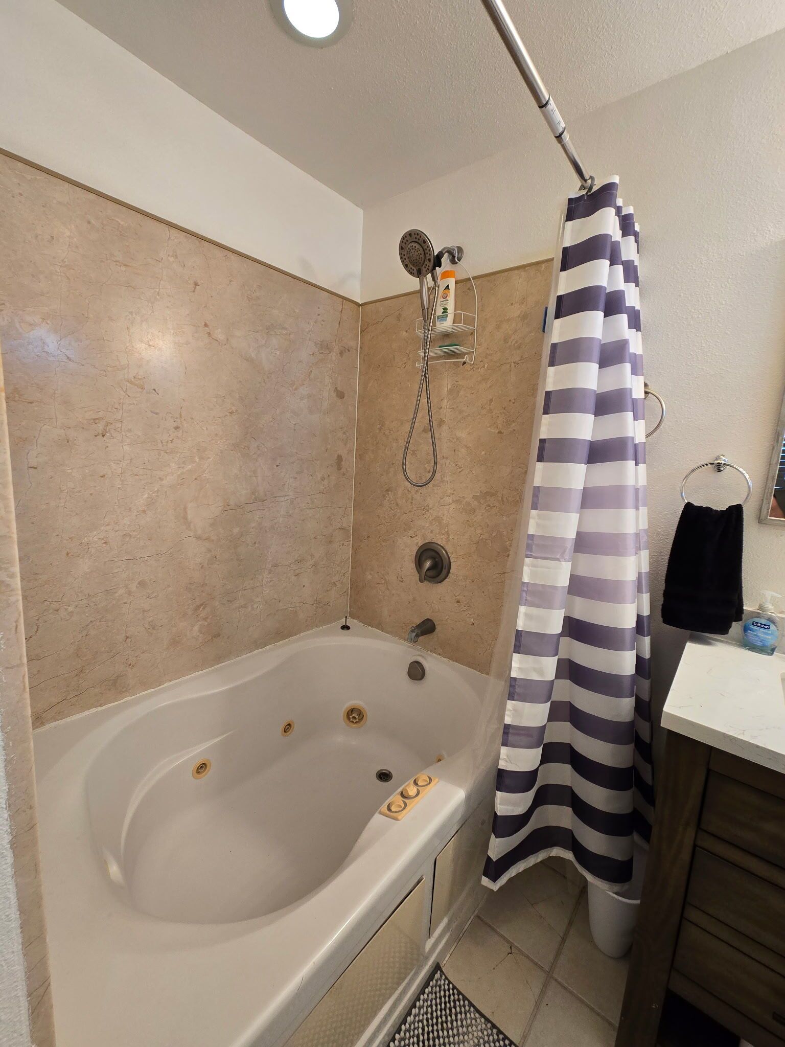 A bathroom with a bathtub, a shower, and a sink.