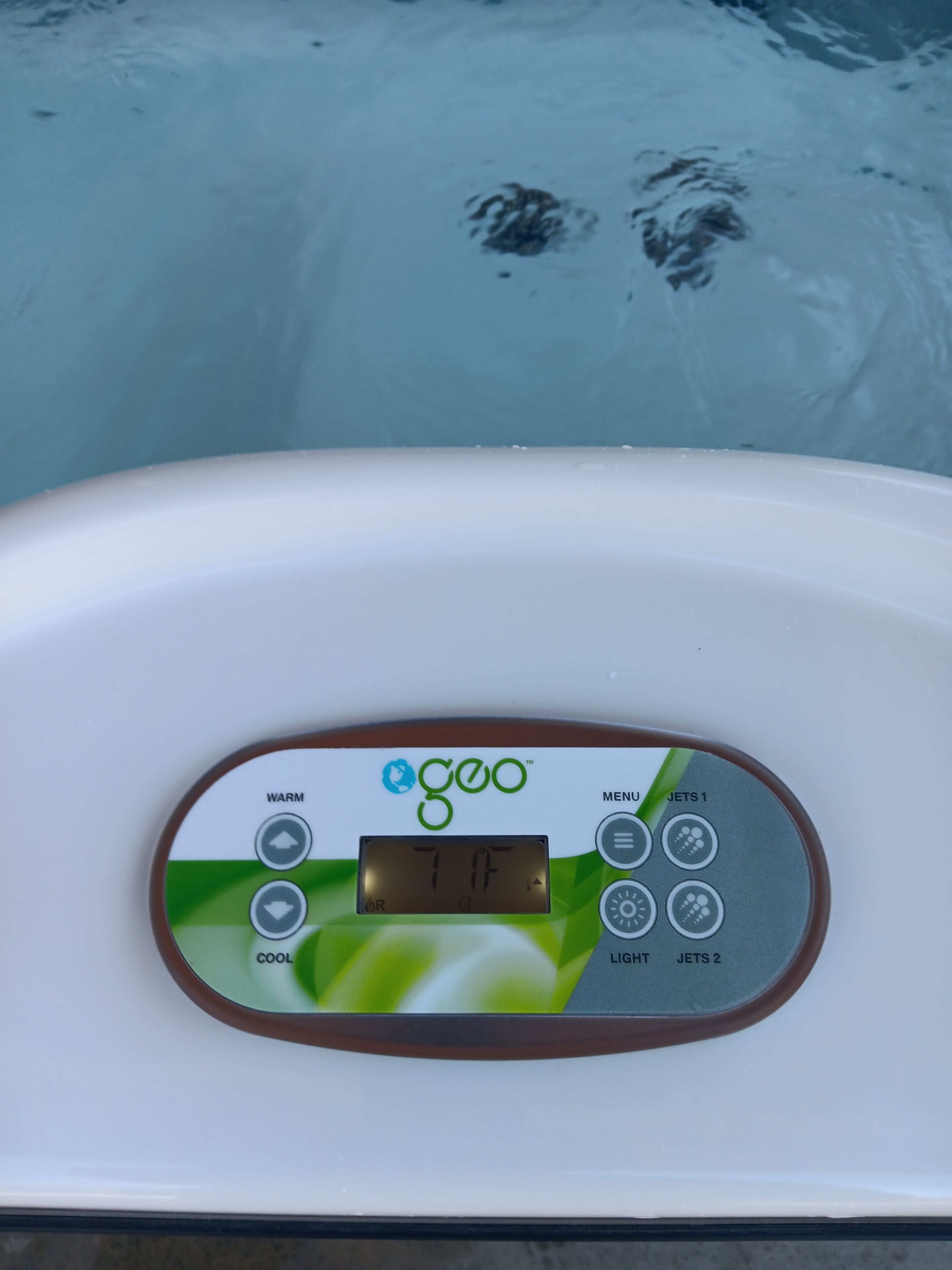 A control panel with temperature settings and jet options.