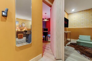 A hallway with a mirror, a wooden cabinet, a small table, and a sofa. - Close to Sunday River: Hot Tub, Sauna, Cold Plunge (Bethel)