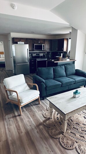 A modern living room with a sofa, a chair, and a coffee table. - Ten Mile Tranquility! Our place is 1/2 mile from Marina with public boat dock. (Ten Mile)